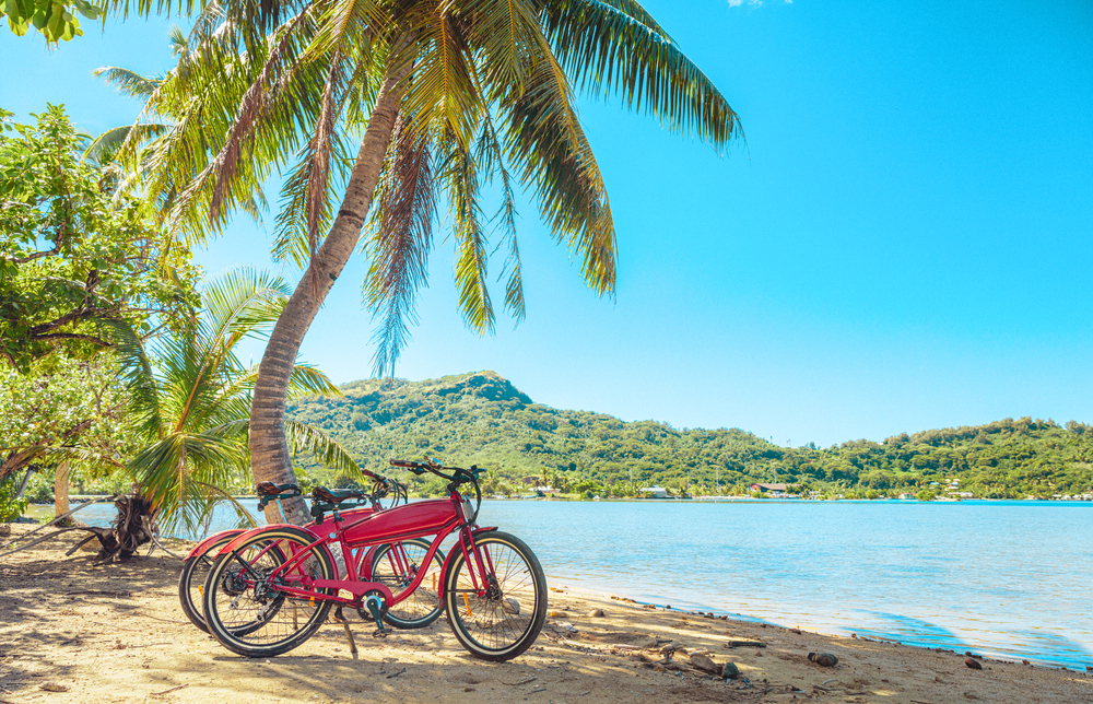 Bicycles pictured on a beach in Bora Bora for a guide to the average prices on the islands