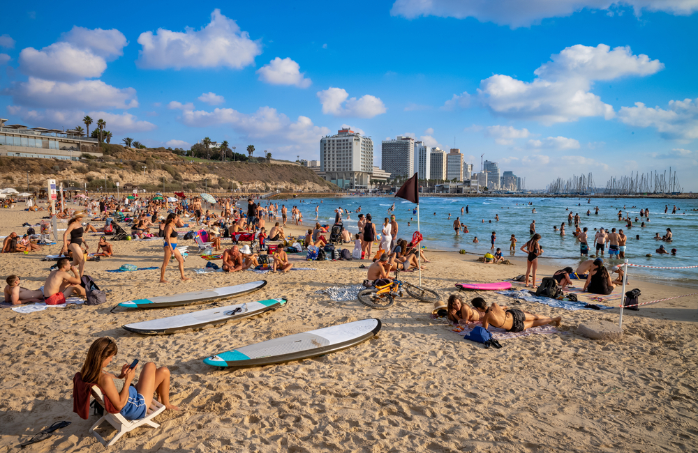 Lots of people one the beach in Tel Aviv pictured during the overall best time to visit the city
