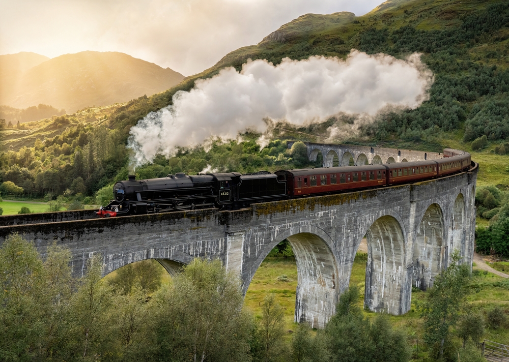 Steam train making its way over the Glenfinnan viaduct in the Scottish highlands