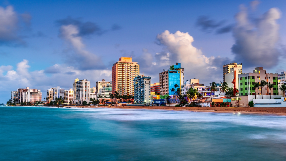 San Juan skyline with hotels and buildings in front of Condado Beach for a Puerto Rico vs the Dominican Republic comparison article