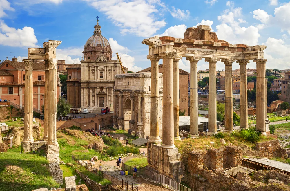 Roman Forum ruins in Italy stand in afternoon sunlight with columns and domes for a list of the best bucket list travel ideas
