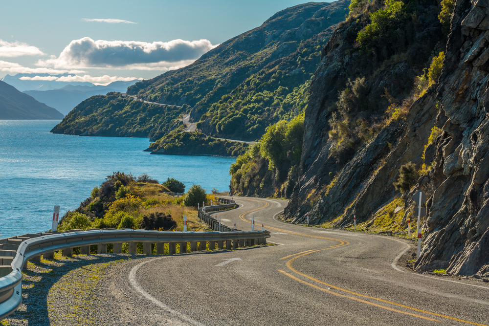 Winding road along Lake Wakatipu in Queenstown pictured for a guide on the average New Zealand trip cost