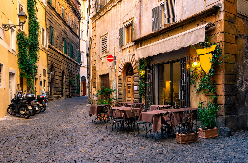 Cozy view of an old street in Rome pictured for a guide to the average Italian trip cost