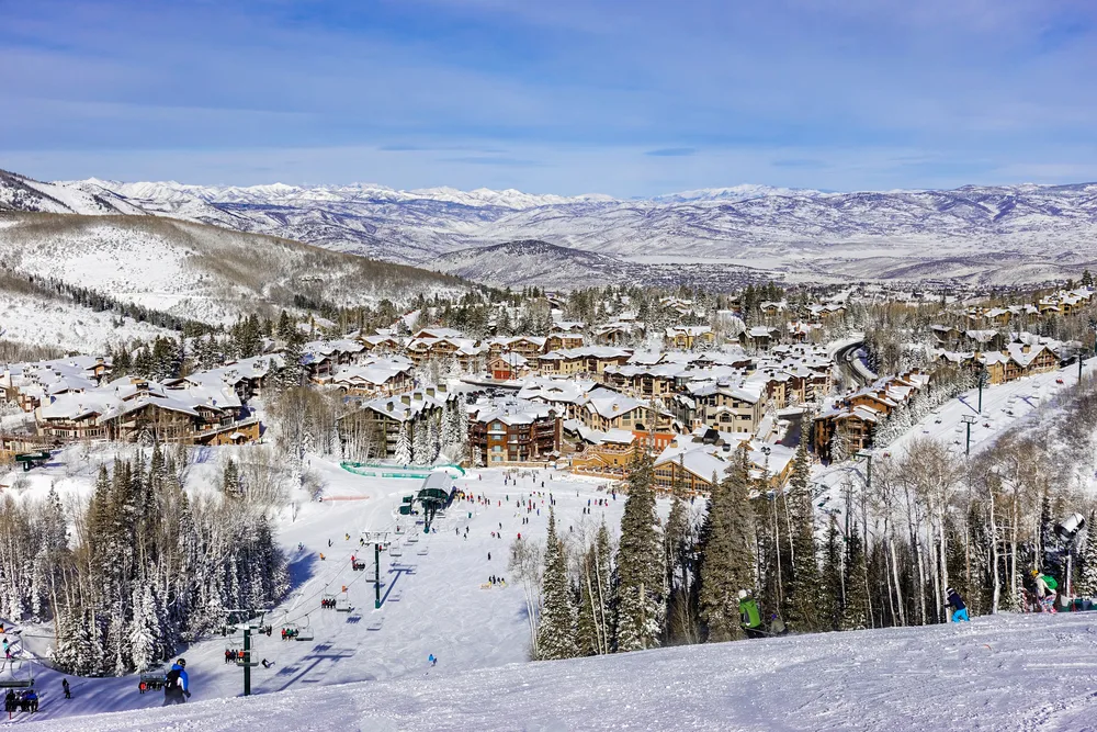 Aerial view of a ski resort in Park City, Utah as skiers ride the chair lift on a clear day, shown as one of the top couples vacation spots in the US