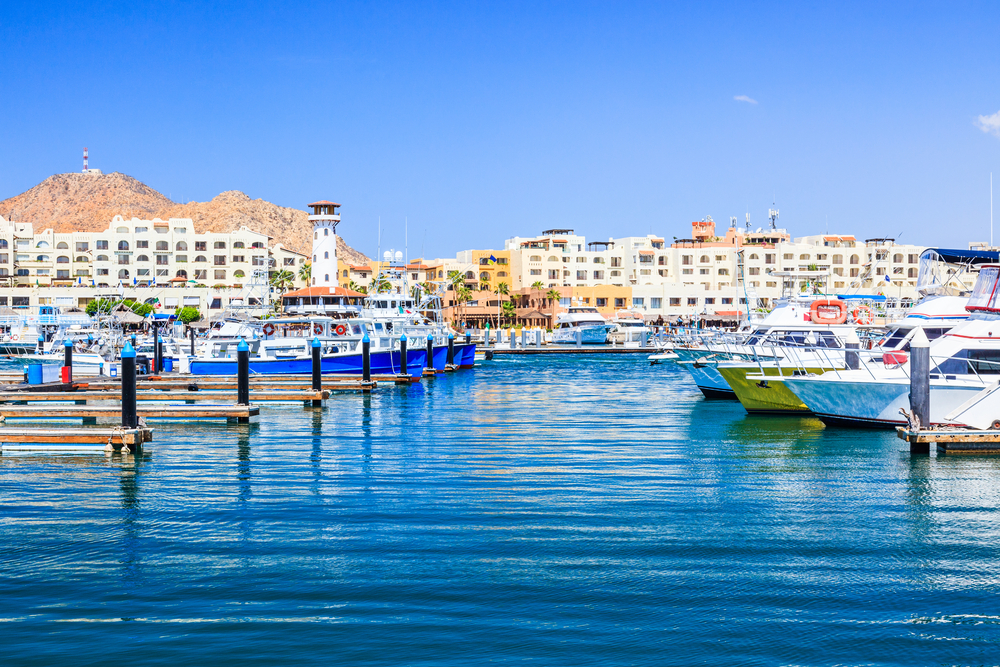 Photo of the marina with lots of fishing boats pictured for a guide titled Trip to Cabo Cost