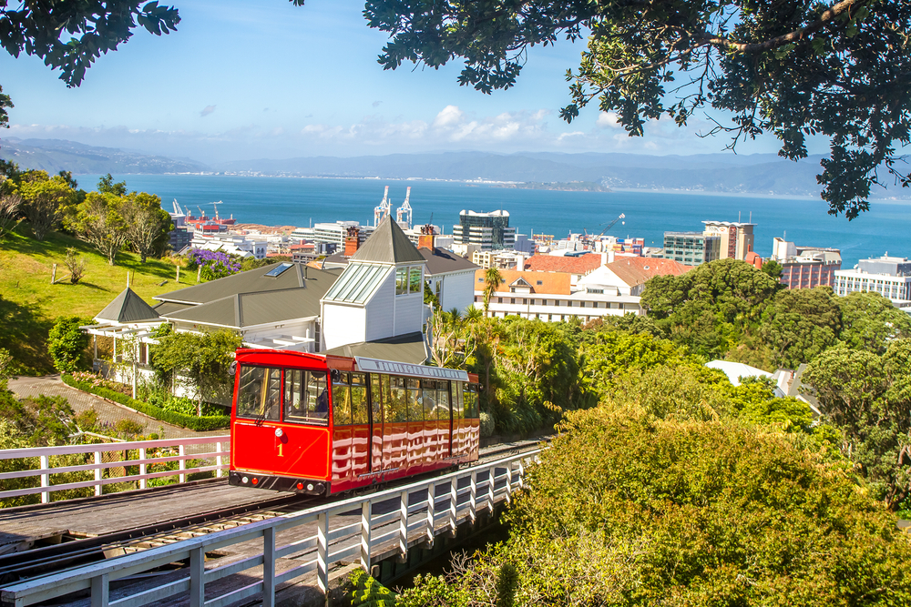 Wellington cable car pictured making its way up the steep mountain for a guide titled What a Trip to New Zealand Costs