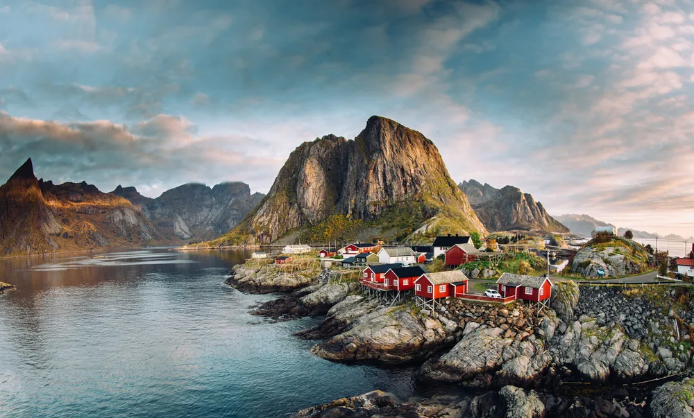 Neat view of dark grey clouds above the fishing village on the Lofoten Islands, pictured for a guide titled What Does a Trip to Norway Cost