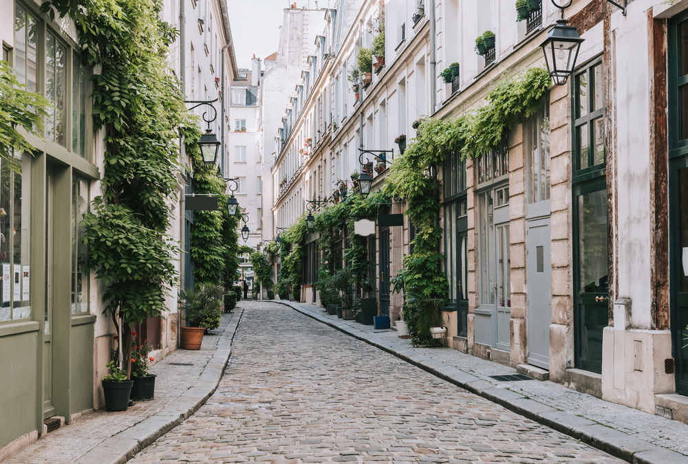 Cobblestone street in old town Paris pictured for a guide on the average Parisian trip cost