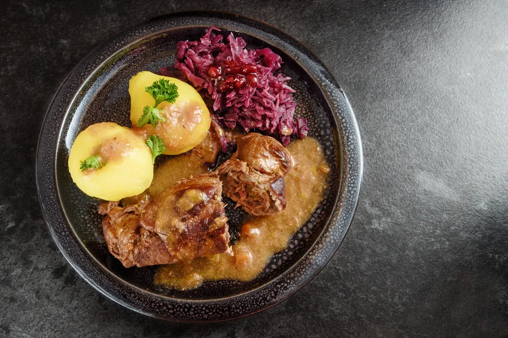 Rouladen, or beef rolls, served on a plate with red braised cabbage and potatoes as a candidate for the best German food to try