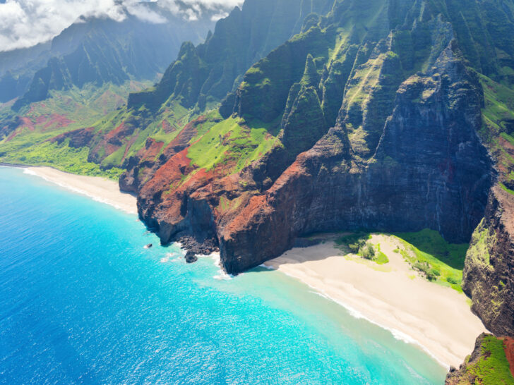 Aerial view of a Napali Coast beach of Kauai with rock formations for a guide to traveling between islands in Hawaii