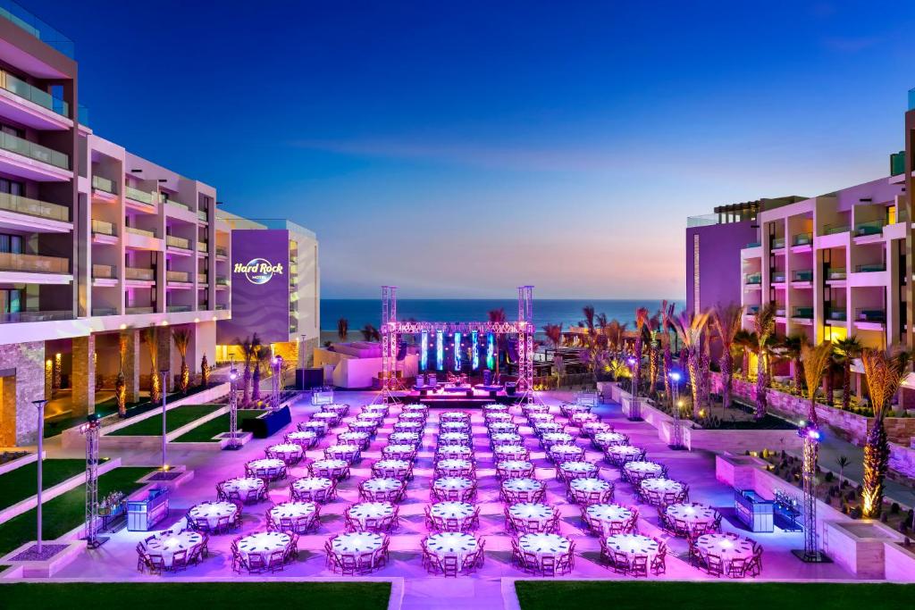 Very cool night image of tables set up below a stage at one of the best family all-inclusive resorts in Cabo, the Hard Rock