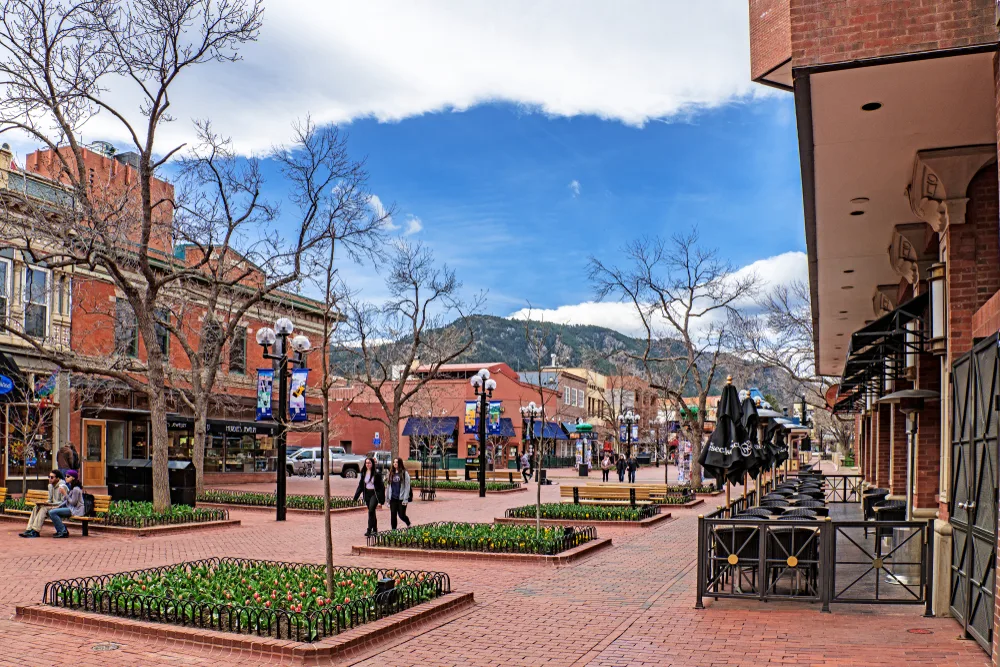 To illustrate that Boulder is one of the best areas to stay in Colorado, a photo of the mountains in the background of the Pearl Street Mall