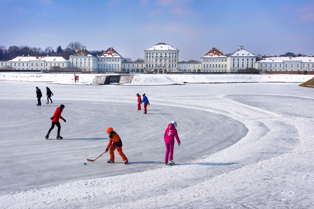 Kids playing ice hockey on a frozen lake in Munich during the winter, the overall worst time to visit
