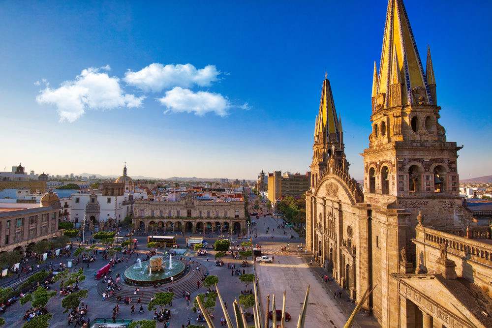 Photo of the Central Landmark Cathedral pictured for a guide titled Where to Stay in Guadalajara with its gold spires and blue sky behind it
