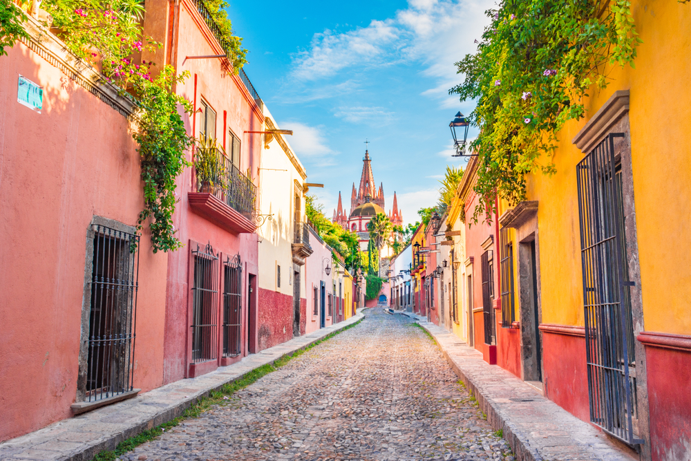 Bright colored buildings in San Miguel de Allende pictured on a nice day in the city, one of our top picks for where to stay in Mexico