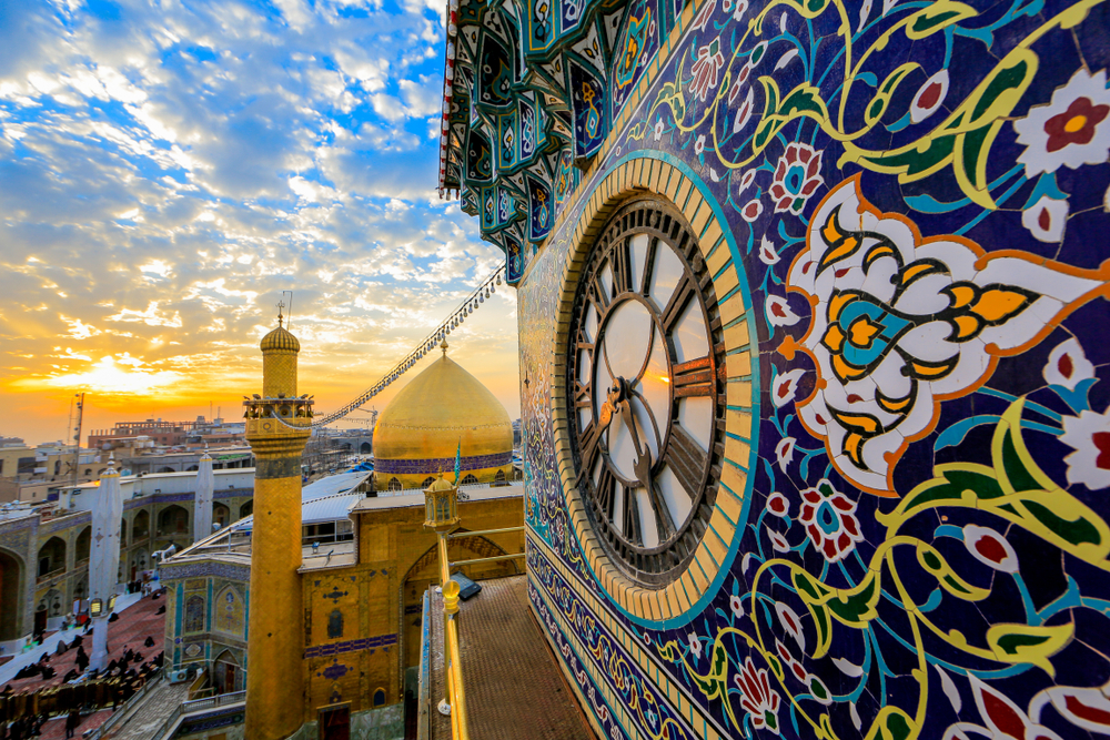 Beautiful colors of the blue and yellow Imam Ali Shrine clock pictured from high above looking down on the historical part of the city of Najaf in Iraq, taken during the best time to visit