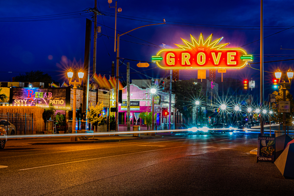 Photo of Midtown St. Louis pictured for a guide titled Where to Stay in St. Louis, with its colorful neon signs and hip exteriors pictured in a long exposure image at night
