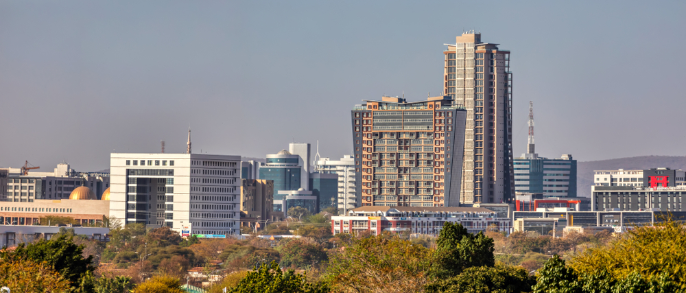 The city skyline of Gaborone, one of the best areas to stay in Botswana, modern building fill the city , viewed from a park.