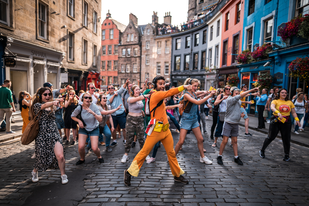 Photo of people dancing at the silent disco during the Fringe for a guide to whether or not it's safe to visit Edinburgh