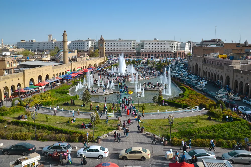 Several people in the middle of the old city of Erbil gathered around the historic Citadel and Bazaar