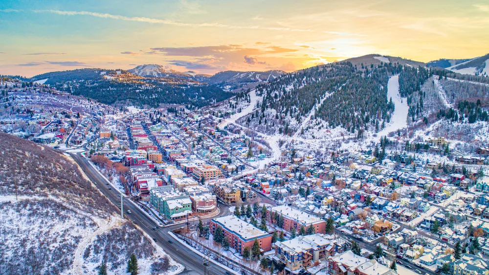 Downtown sunrise aerial view of Park City, Utah for a ranking of the best places to visit in the US during winter with snow on the ground
