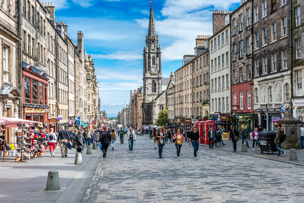 People walking around the Royal Mile in Edinburgh for a guide to whether or not the city is safe to visit