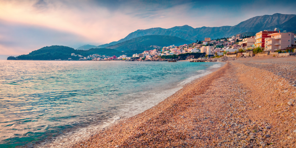 View of a beach in Himare, Albania at dusk on the Adriatic Sea for a list of the best places for solo travel worldwide