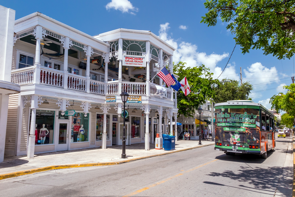 Trolley in Old Town Key West pictured on a nice day with the Picher's Crab Shack in by the street