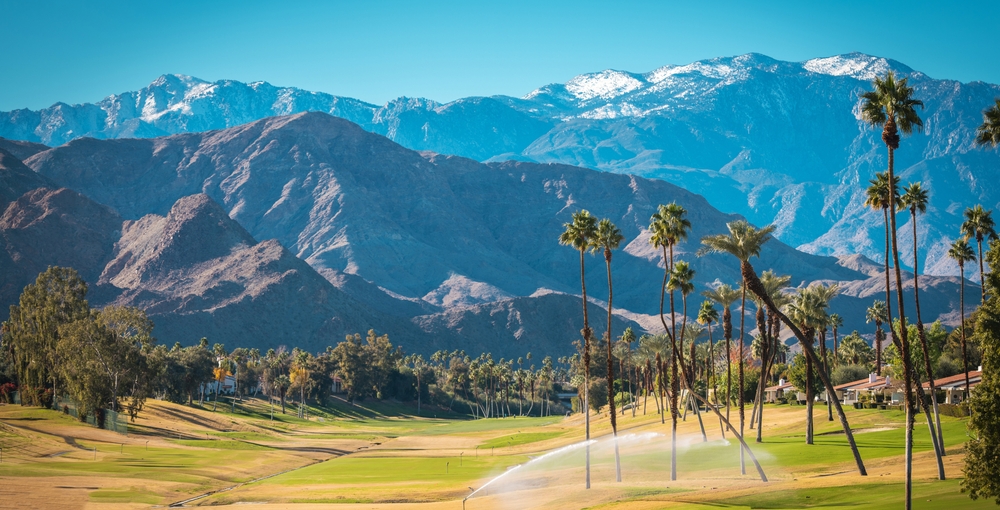 View of Palm Springs, California palm trees and snow-capped mountains that rank this as one of the best places to visit in the United States during winter