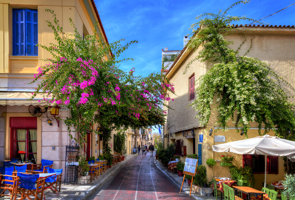 Quaint streets of Plaka pictured for a guide titled Is Athens Safe to Visit with tourists strolling about