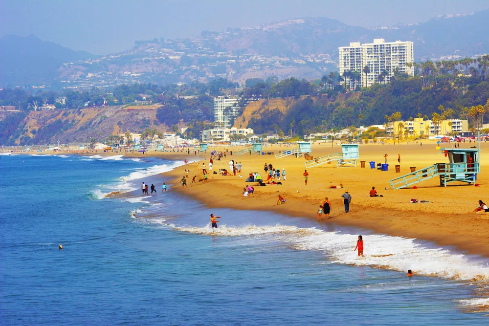 People in the ocean as seen from the Santa Monica Pier to show the culture of Southern California