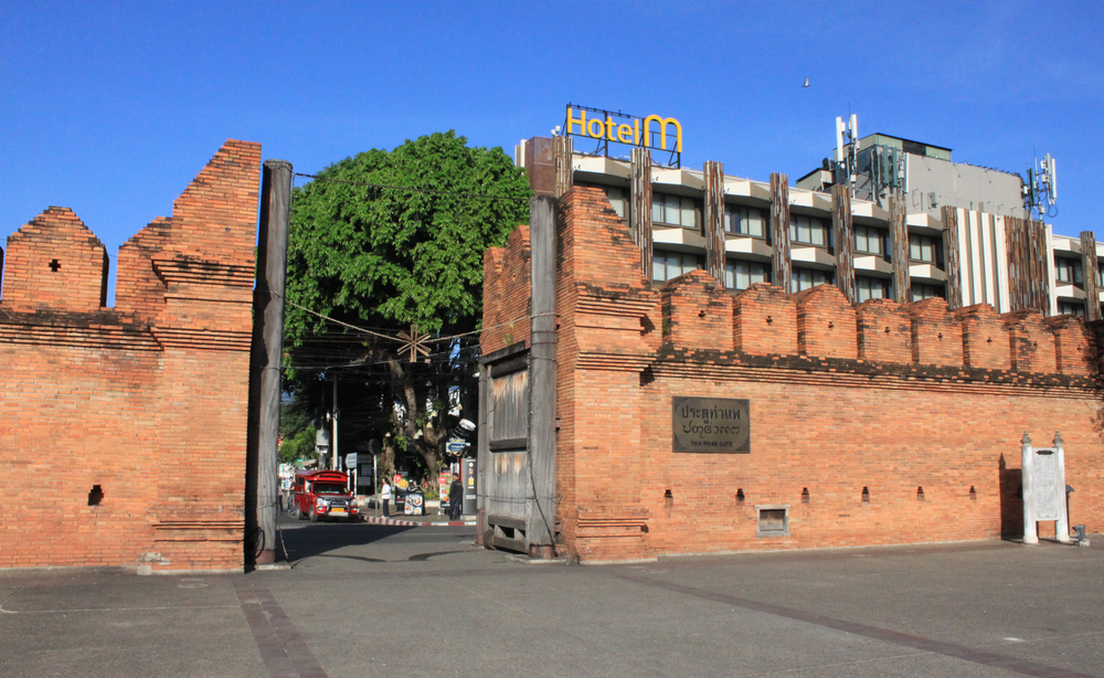 Photo of the Tapae Gate, with its towering walls that increase as they get toward the entrance, and giant wooden gates that open inward, in one of the city's entrances, pictured for a guide to whether or not Chiang Mai is safe to visit