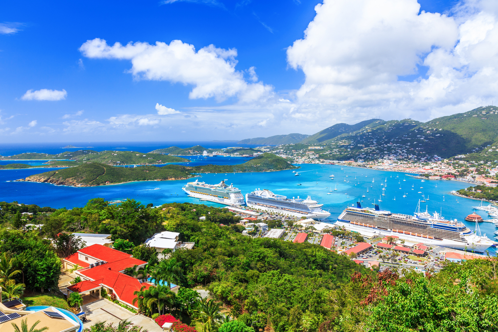 An aerial photo on several islands where large cruise ships are docked on the pier, a piece on a guide about Virgin Islands trip cost.