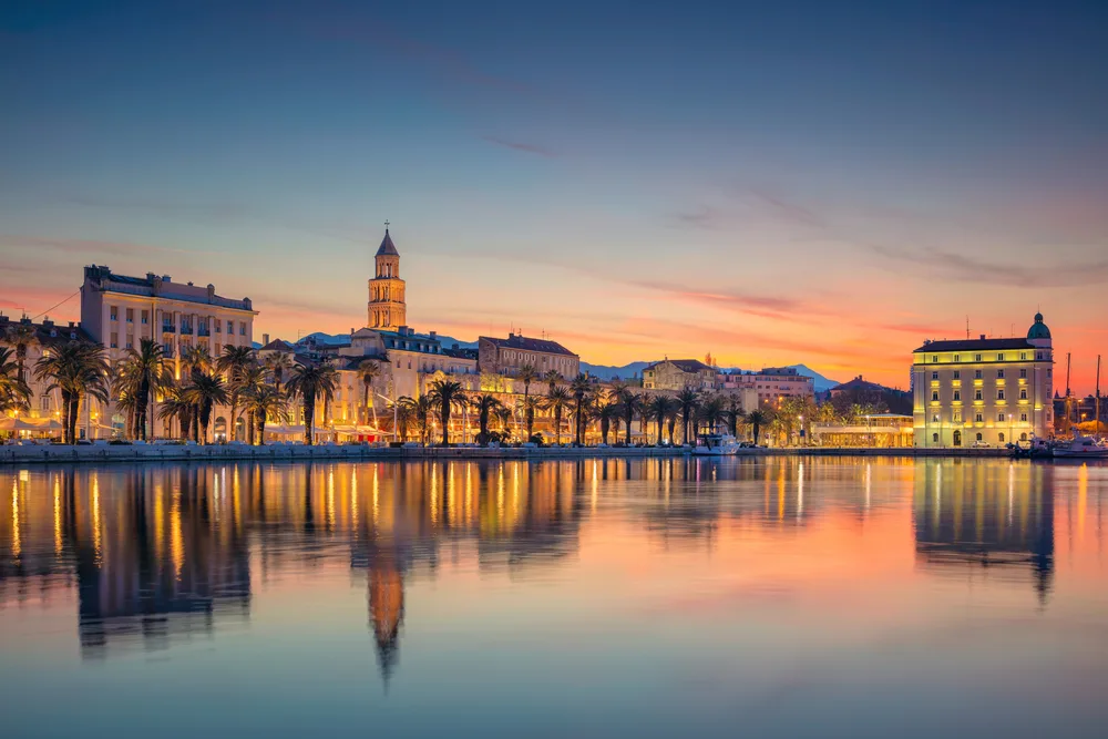 The city skyline majestically reflected on a bay beside it during sunset in Split, one of our picks on the best areas to stay in Croatia.