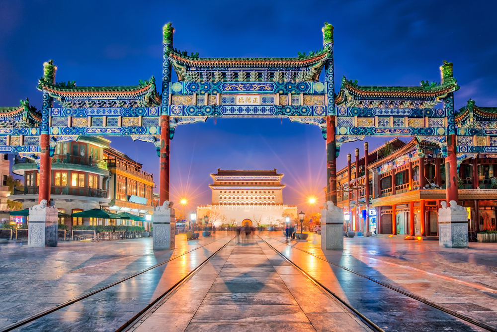 Beijing Zhengyang Gate with lights shining at dusk in one of the best tourist destination cities in the world
