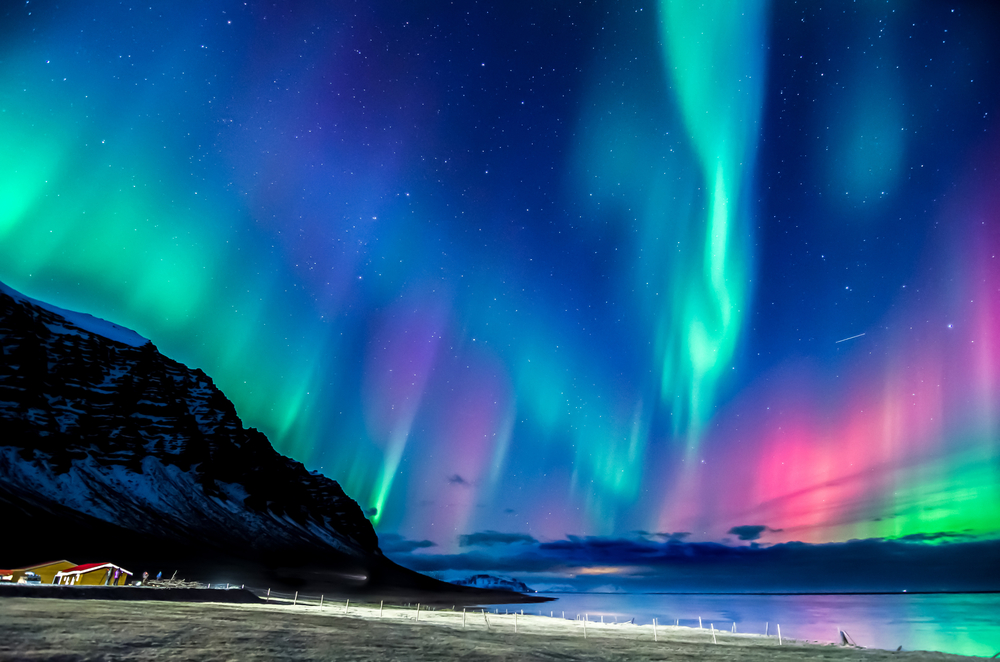 Colorful Northern Lights dancing in the skies over Iceland, one of the best places for solo travel in the world
