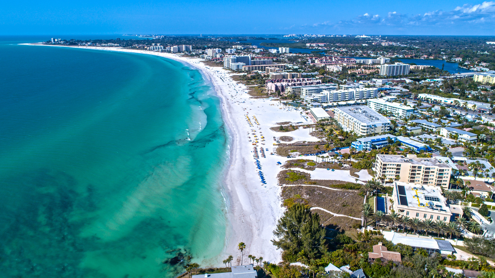 Aerial shot of Siesta Key Beach in Sarasota, Florida for a list showing the top 8 places to visit in the US during winter