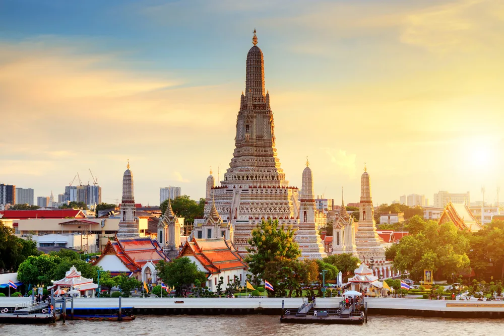 Wat Arun temple in Bangkok, Thailand during sunrise by the river to show why this city is one of the best destinations for tourists in the world