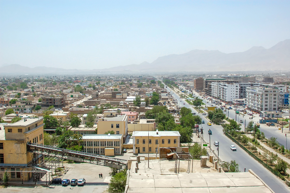 Empty street in Kabul pictured during the overall least busy time to visit the city, as seen from the air with a street running down the middle of the city