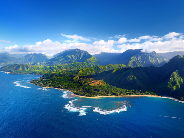 Aerial view of the Napali Coast in Kauai for a guide answering how long is a flight to Hawaii with average flight times for different islands