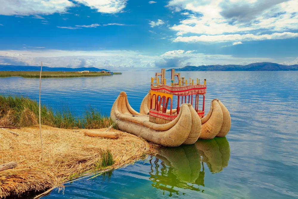 A totora boat docked on the small land area of Lake Titicaca, the wold's largest navigable lake, one of the facts about Bolivia.