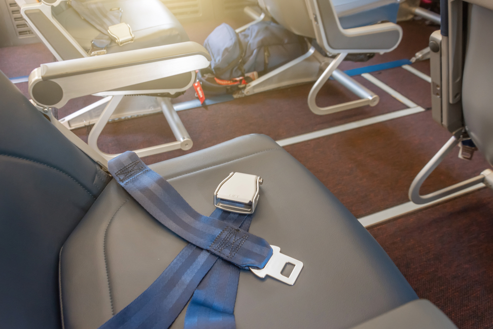 Airplane empty seats showing the concept of is a backpack a personal item with the bag lying under the seat 