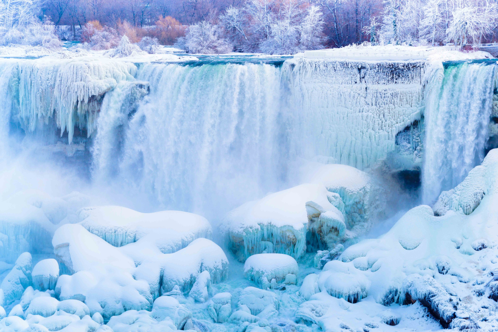 A large waterfalls completely frozen during the winter season. 