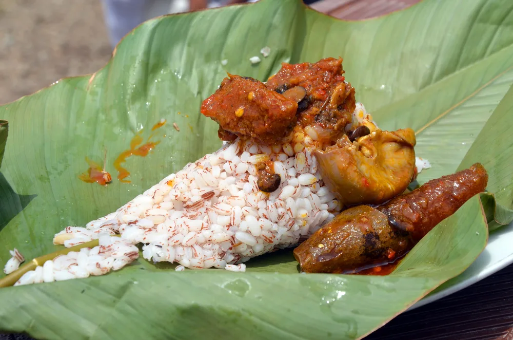 A local food, rice with a piece of meat, prepared on a leaf.