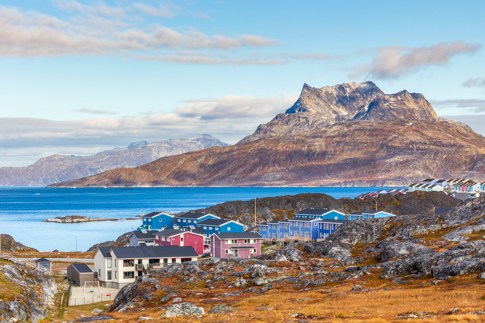 A suburb area of Nuuk Outskirts, one of the best areas to stay in Greenland, the town is located on the rocky coastal area and on the opposite side are tall mountains.