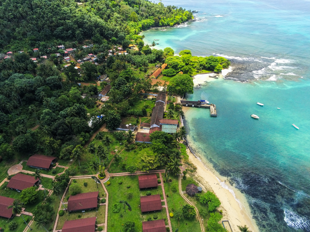 Aerial view of a beach in São Tomé and Príncipe, two of our picks on the best area to stay in Gabon, where the portion of the land is covered with green fields and trees, where few houses and hotels are built. 