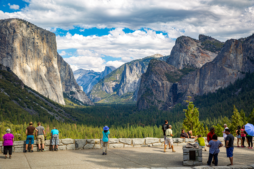 People enjoying the vast view of the Yosemite National Park on a viewing area. 