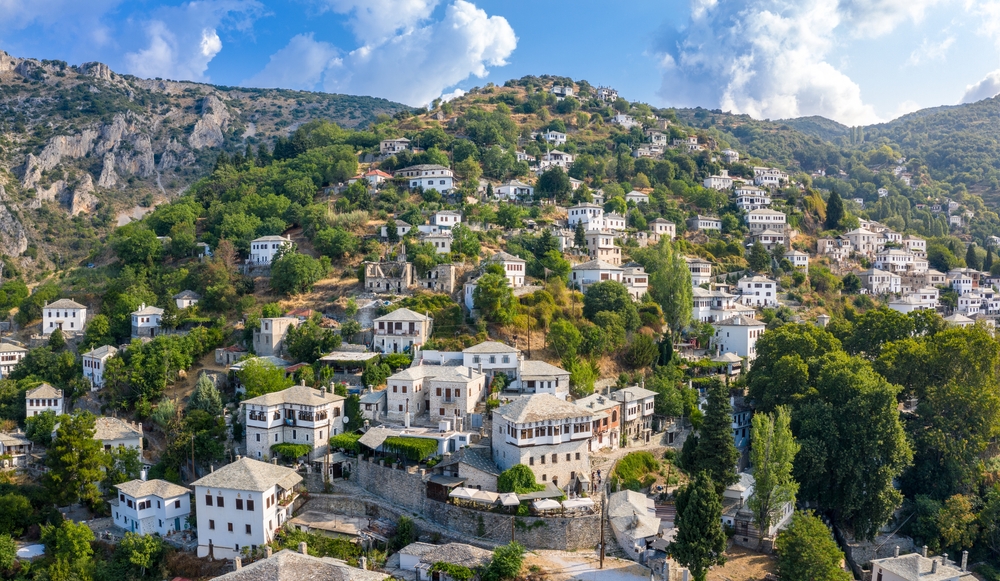 A town that is built on the side of the mountain where houses are all white, one of the mountainous terrain in the land of Greece.
