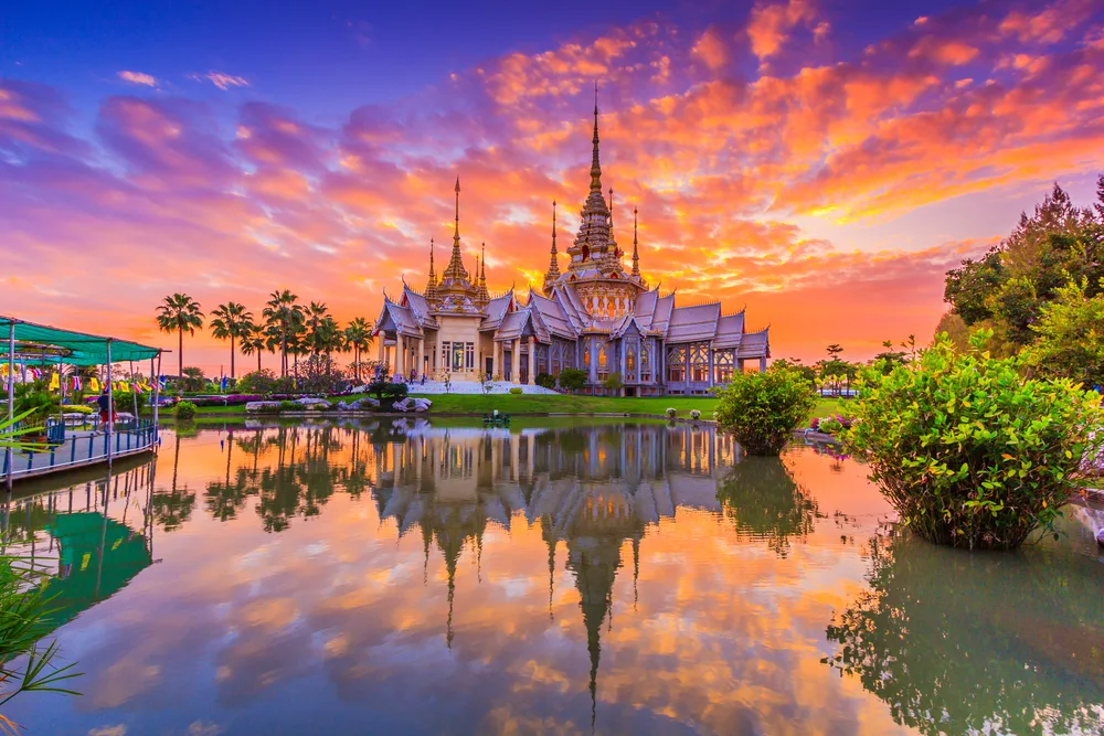 Wat Thai landmark seen at sunset in Wat None Kum in Nakhon Ratchasima province for a guide answering how long does it take to fly to Thailand from the US