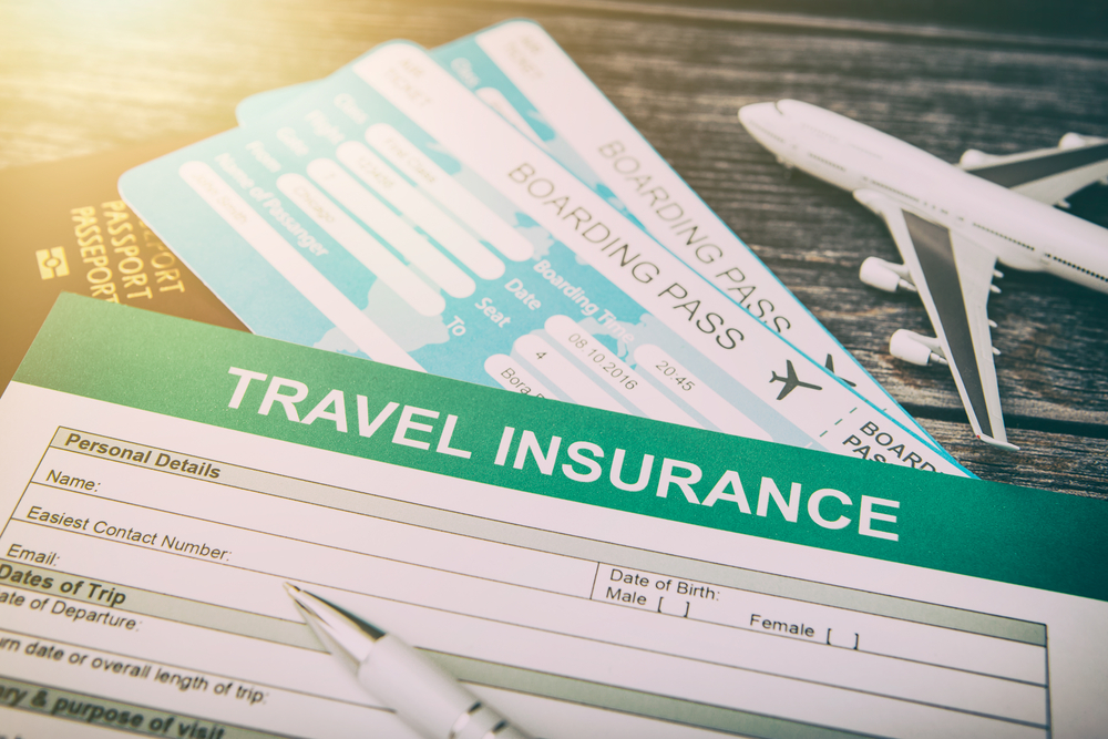 Concept of travel insurance and free cancellation for flights with plane toy and boarding passes on the table with insurance documents and pen